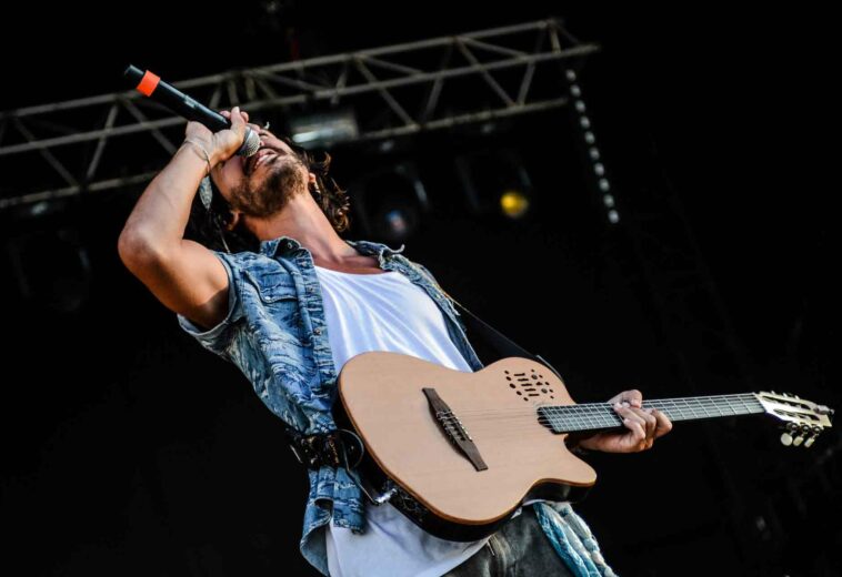 man-using-brown-and-black-electric-guitar-while-singing-167446